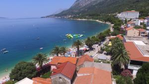 a view of a beach with a boat in the water at Apartmani Crkvina in Gradac