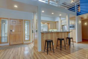 a kitchen with two bar stools and a counter at 1 Colonial in Sunriver