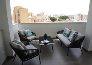 a balcony with chairs and a table and a window at Dimora Mothia in Marsala