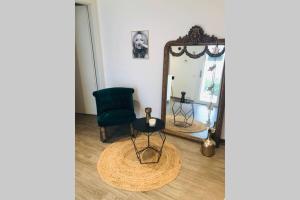 a mirror and a chair in a room at Beautiful Cocoon in Neuchâtel