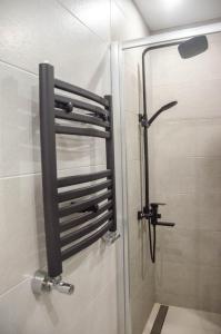 a shower in a bathroom with a glass door at Kokos Avenue Loft Apartments in Yuzhne