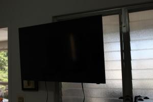 a flat screen television sitting in a window at Hermosa Residencia Costa Azul Acapulco in Acapulco