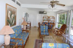 a living room with a couch and a table and chairs at Gran Villa Costa Azul Acapulco in Acapulco