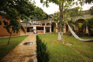 a garden with a hammock in front of a house at Hacienda Molino Santo Domingo in San Cristóbal de Las Casas