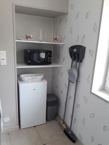 a kitchen with a microwave and a small refrigerator at Logis de LANGE studio 2 p in Saint-Hilaire-la-Palud
