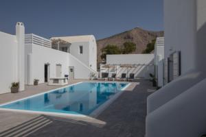 a swimming pool in the middle of a building at Petra Aqua Villa in Perissa