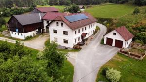 an overhead view of a large white house with a solar roof at Landhof Böhm in Arbesbach