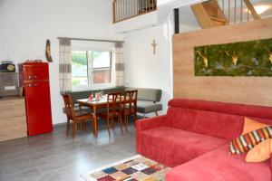 a living room with a red couch and a table at Landhof Böhm in Arbesbach