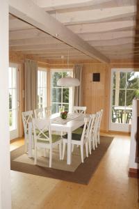 a white dining room with a white table and chairs at Ferienhaus Albrecht in Egg