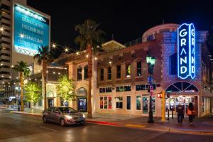 a city street at night with a car parked in front of a building at Downtown Grand Hotel & Casino in Las Vegas