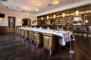 a long dining room with a long table and leather chairs at Downtown Grand Hotel & Casino in Las Vegas