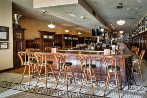 a bar with chairs and a counter in a restaurant at Downtown Grand Hotel & Casino in Las Vegas