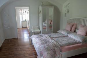 a bedroom with a bed and a room with two beds at Gutshof Bartl 2 in Klagenfurt