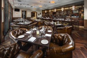 a restaurant with leather seats and tables and a bar at Downtown Grand Hotel & Casino in Las Vegas