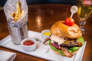 a hamburger with a tomato on top and french fries at Downtown Grand Hotel & Casino in Las Vegas