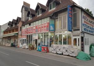 a store fronts on the side of a street at Guesthouse Meče in Bijelo Polje