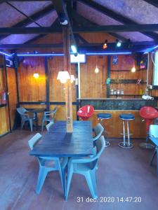 a blue table and chairs in a room with a bar at Pensiunea Mir in Bran