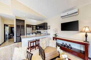 a living room with a bar and a kitchen at The Cove 6 at Playa Ocotal in Ocotal