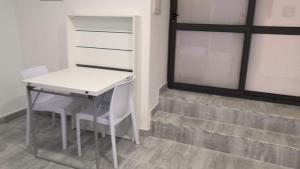 - une table et des chaises dans une chambre avec fenêtre dans l'établissement Maria e Antonio Blu, à Castellammare di Stabia