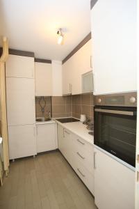 a kitchen with white cabinets and a sink at T&A in Paraćin