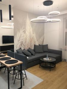 a living room with a couch and two tables at Apartamenty Premium Loft in Wadowice