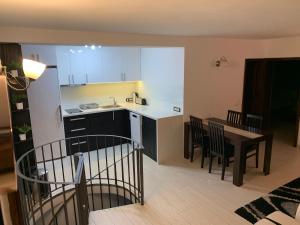 a kitchen and dining room with a table and chairs at Supilova Apartments in Belgrade