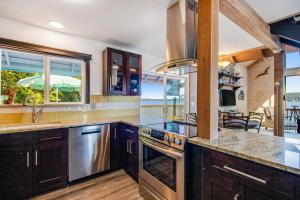 a kitchen with a sink and a stove top oven at Captain's Quarter in Johnson Landing +25 photos