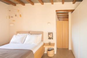 A bed or beds in a room at Avdos' olive house - land tales