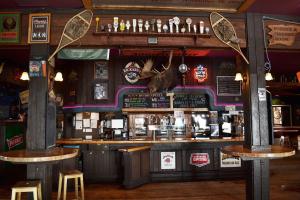 a bar with two stools in front of it at Village Center 2 bedroom Condo in Big White