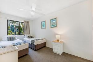 a bedroom with two beds and a window at Surfers Paradise- meters from the beach! in Gold Coast