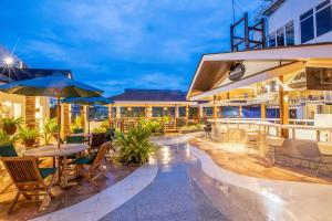 an outdoor patio with tables and chairs at Solano Hotel in Lipa