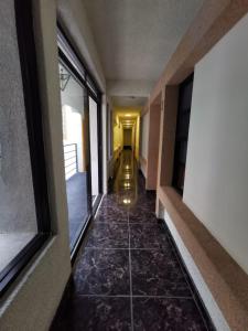 a hallway of a building with a tile floor at Alquería Central hotel in Tlaxco de Morelos