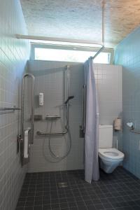 a bathroom with a shower and a toilet at Avenches Youth Hostel in Avenches