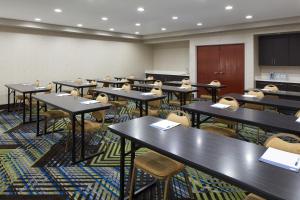 a classroom with rows of tables and chairs at Holiday Inn Express & Suites Asheville SW - Outlet Ctr Area by IHG in Asheville +38 photos