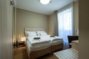Postel nebo postele na pokoji v ubytování Horský hotel Lorkova vila