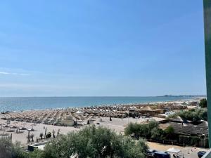 a beach with a lot of umbrellas and the ocean at Fancy Studio with Sea View in Mamaia