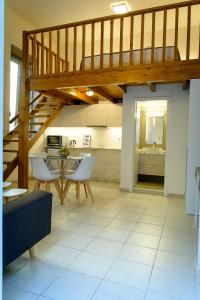 a kitchen with a staircase and a table and chairs at Uni Island - City Center Suites in Heraklio