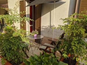 eine Terrasse mit einem Tisch, einem Stuhl und einem Sonnenschirm in der Unterkunft La Buccetta B&B in Verona