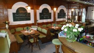 a restaurant with tables and chairs and a vase of flowers at sWirtshaus M&N in Zeltweg