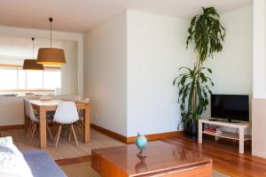 a living room with a table and a dining room at The Refreshing Seaside Home in Matosinhos