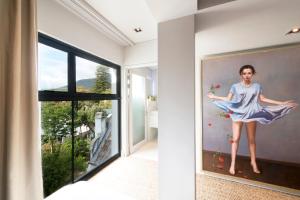 a painting of a woman in a dress on a wall in a room at Collection Luxury Apartments - Concord 11 in Stellenbosch