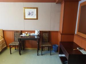 a dining room with a table and two chairs at Gagarin Hotel in Yuzhno-Sakhalinsk