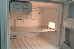 an empty refrigerator with its door open with its at Golden Mount Rest Townside in Mount Morgan