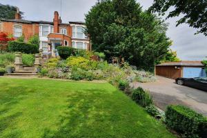 a house with a garden in front of a yard at Spectacular Period Property Located In Leicester in Leicester