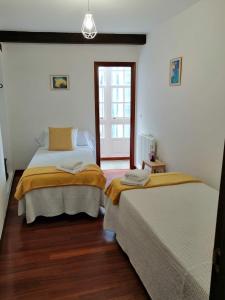 a bedroom with two beds and a window at SE@SE a 100m.Catedral. in Santiago de Compostela