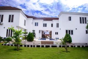 a large white house with a yard at House4 in Lekki