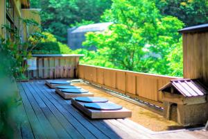 a row of seats on a wooden deck at Hakone Yumoto Onsen Hotel Kajikaso in Hakone