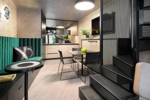 a kitchen with a table and chairs in a room at Court 5 in Zagreb