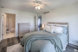 a bedroom with a bed and a ceiling fan at Benton Harbor Lake House with Dock and Fire Pit! in Woodland Beach