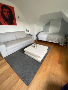 a living room with a couch and a bed at BB La Marinière in Theux +22 photos